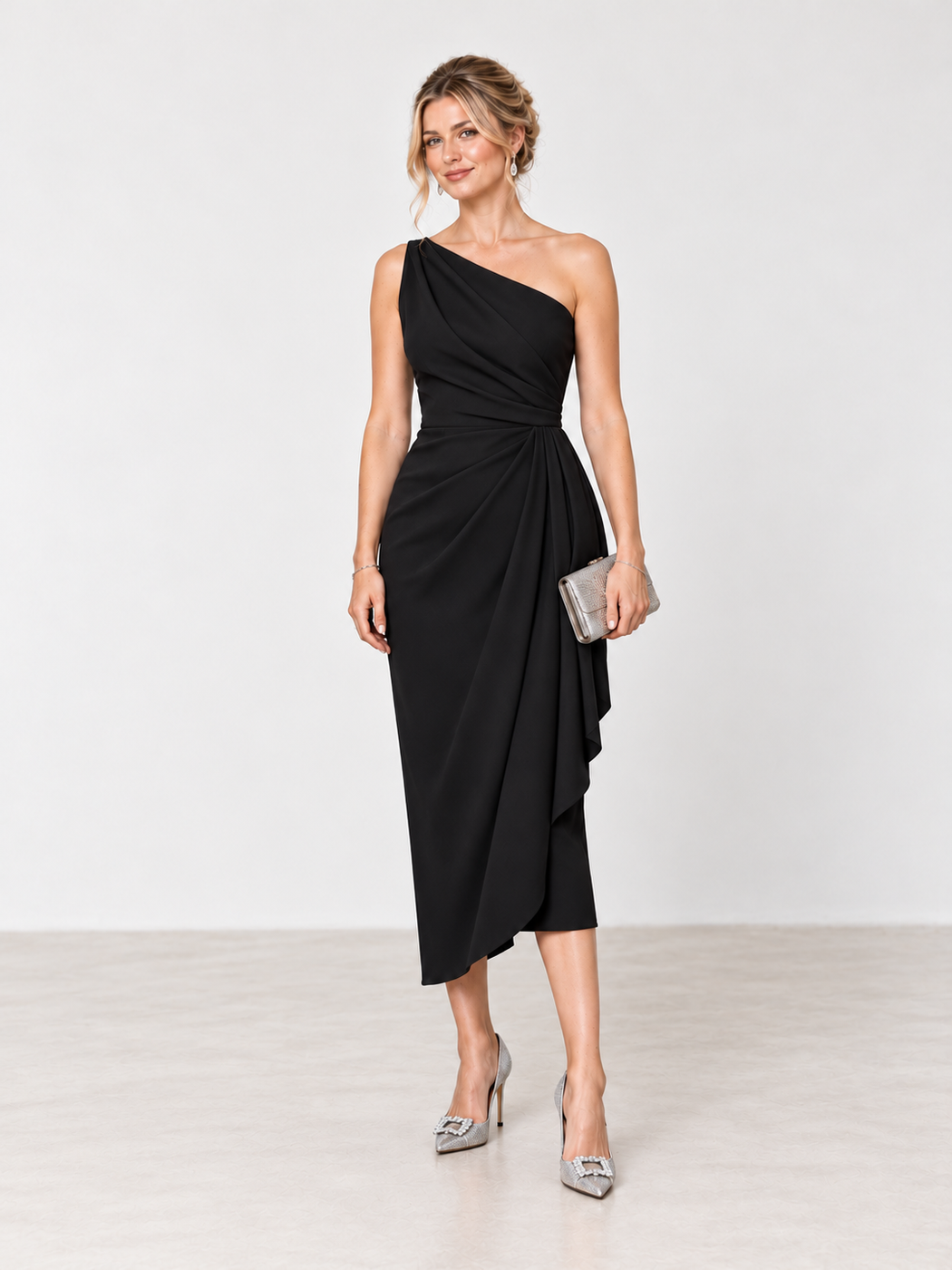 Black one-shoulder draped midi dress with silver embellished heels