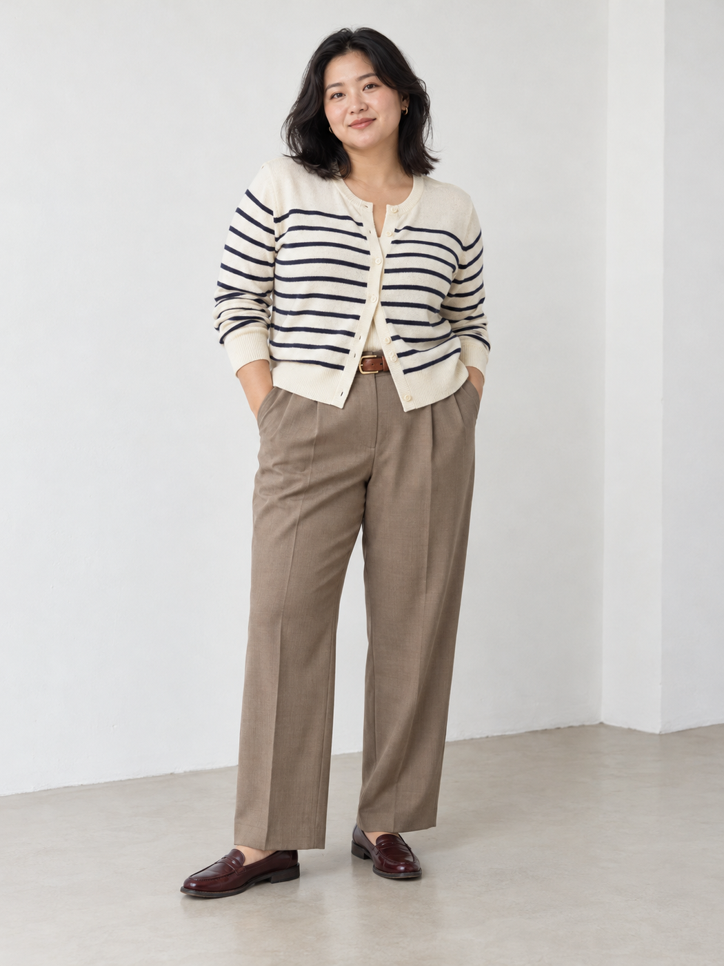 Navy-striped cream cardigan with taupe pleated trousers and burgundy loafers