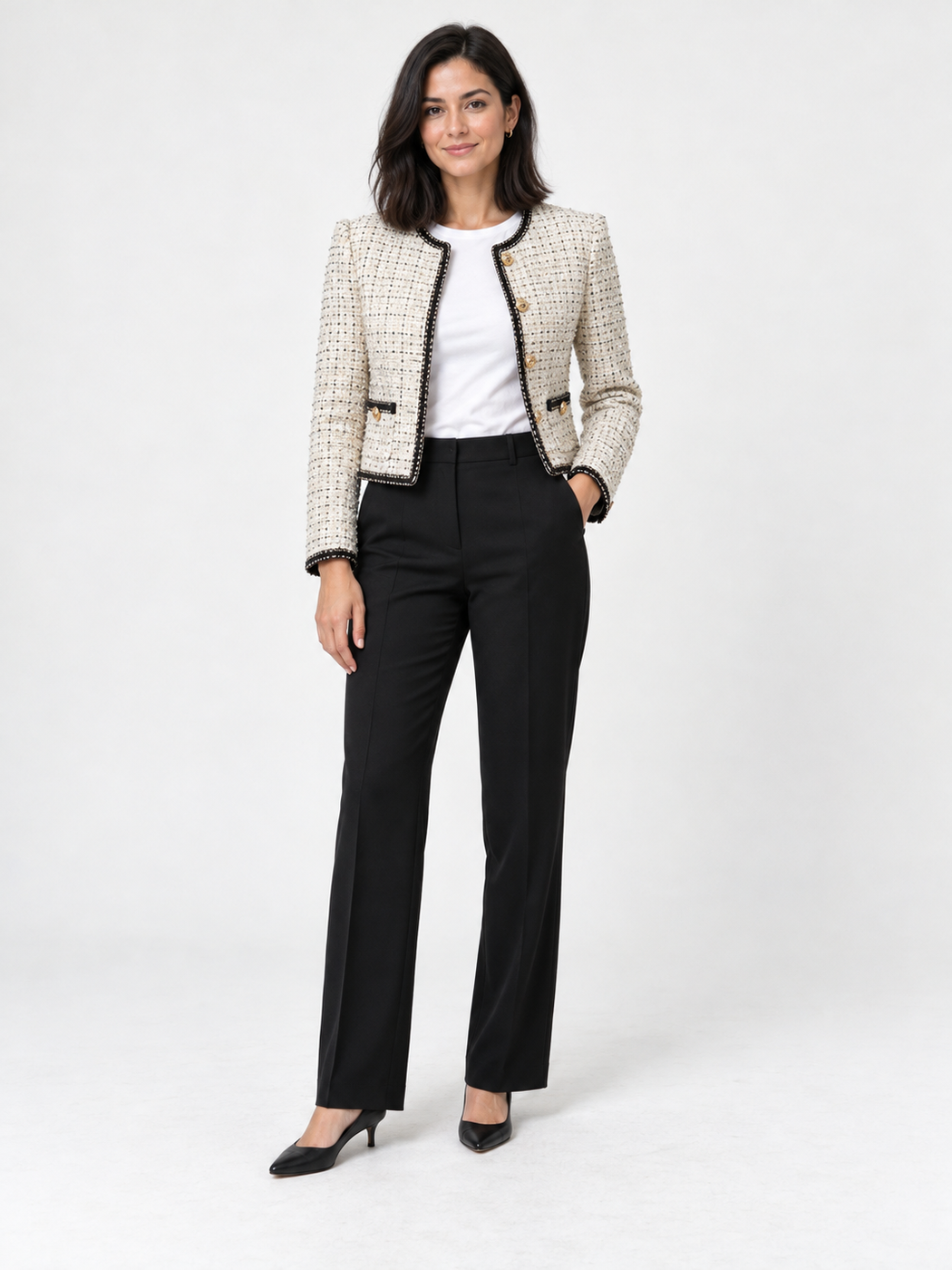 Cream tweed jacket with a white top, black trousers and black flats